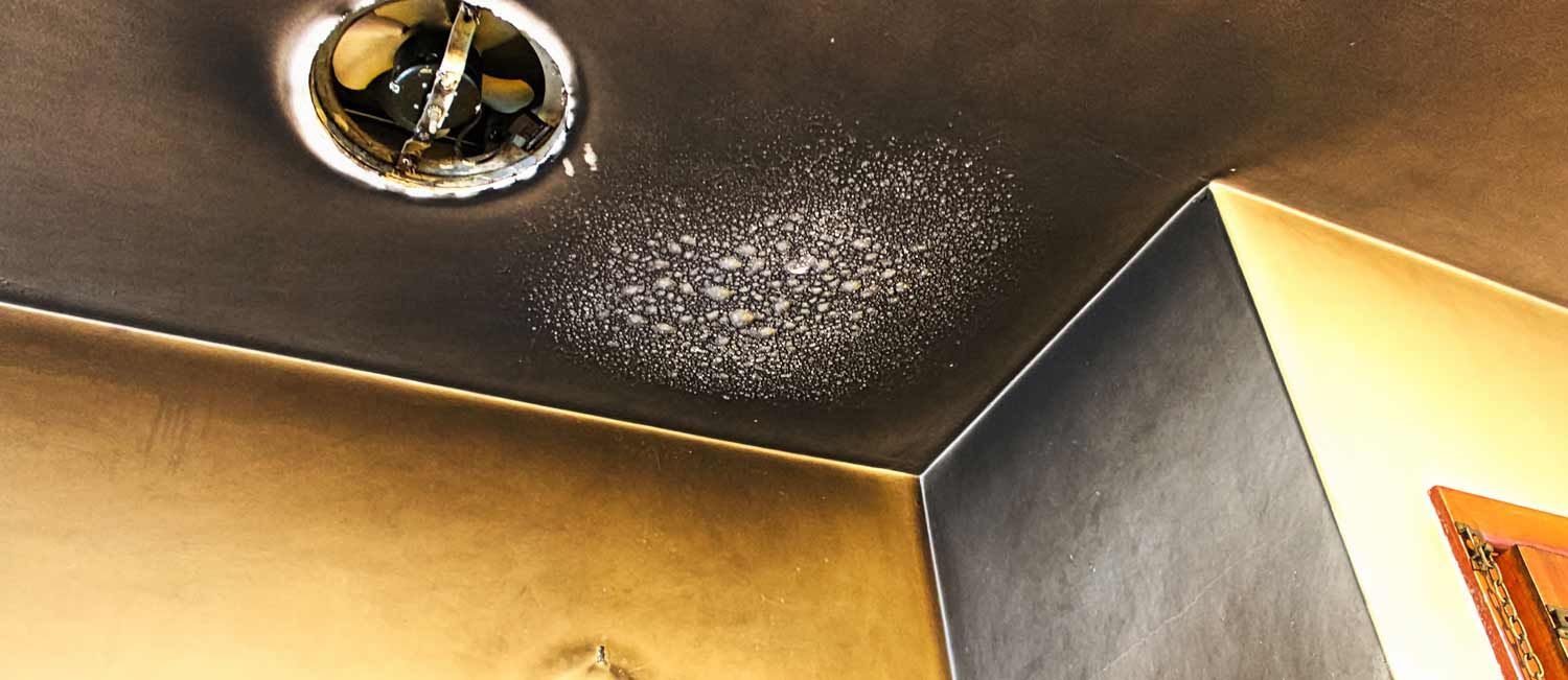 A close up of a ceiling with smoke coming out of it.