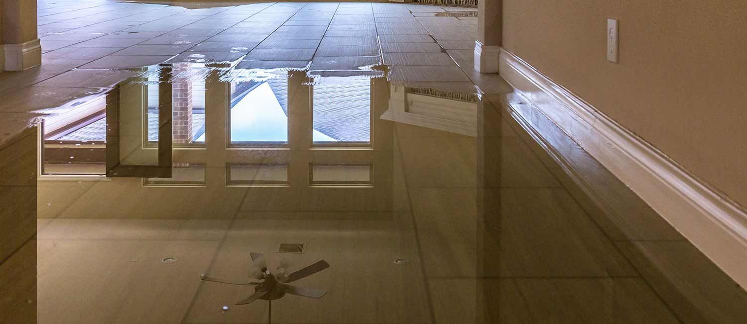 A hallway with a reflection of a building in the floor.