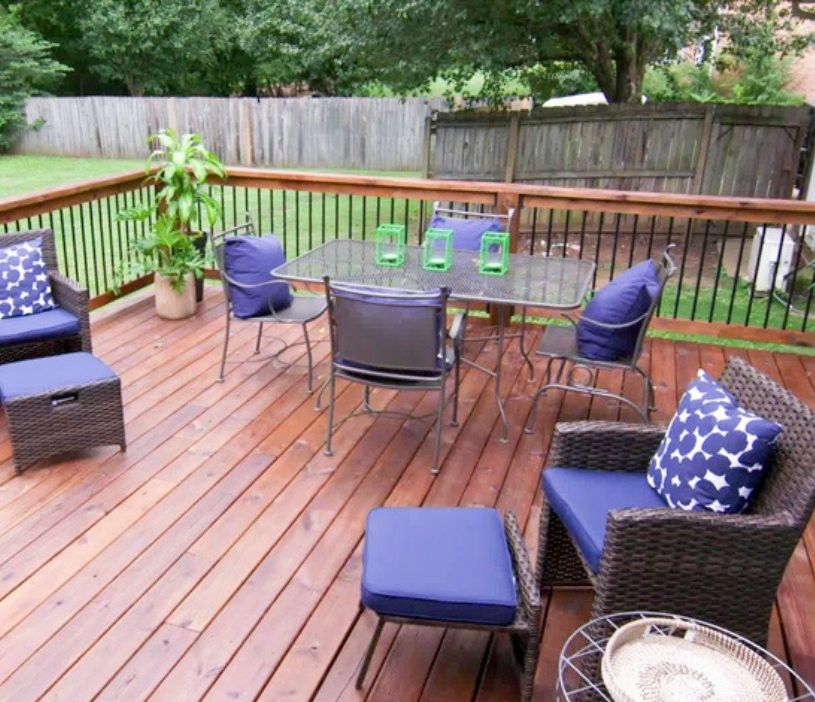 A wooden deck with a table and chairs on it