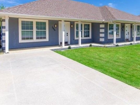A blue house with white trim and a covered porch