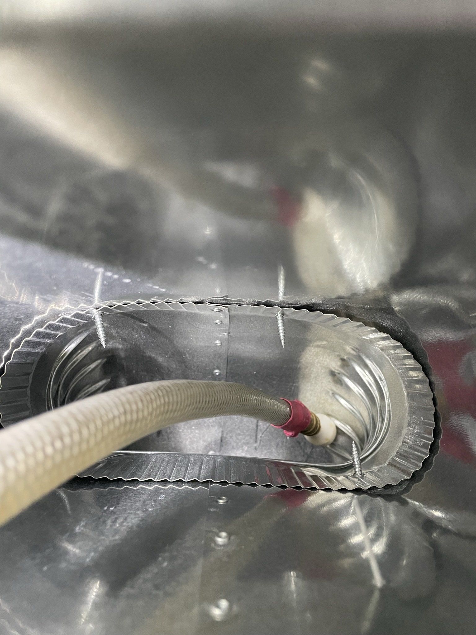 A hose with sheet of metal inside the vent