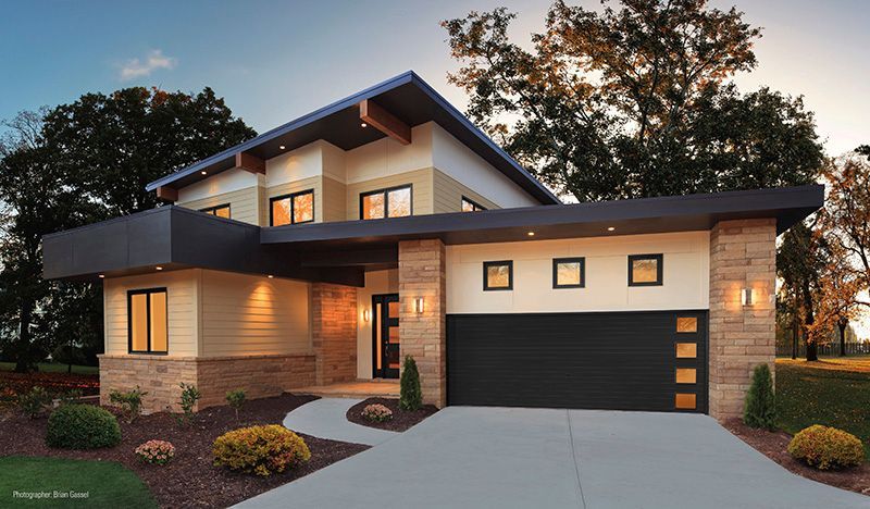 A modern house with a black garage door