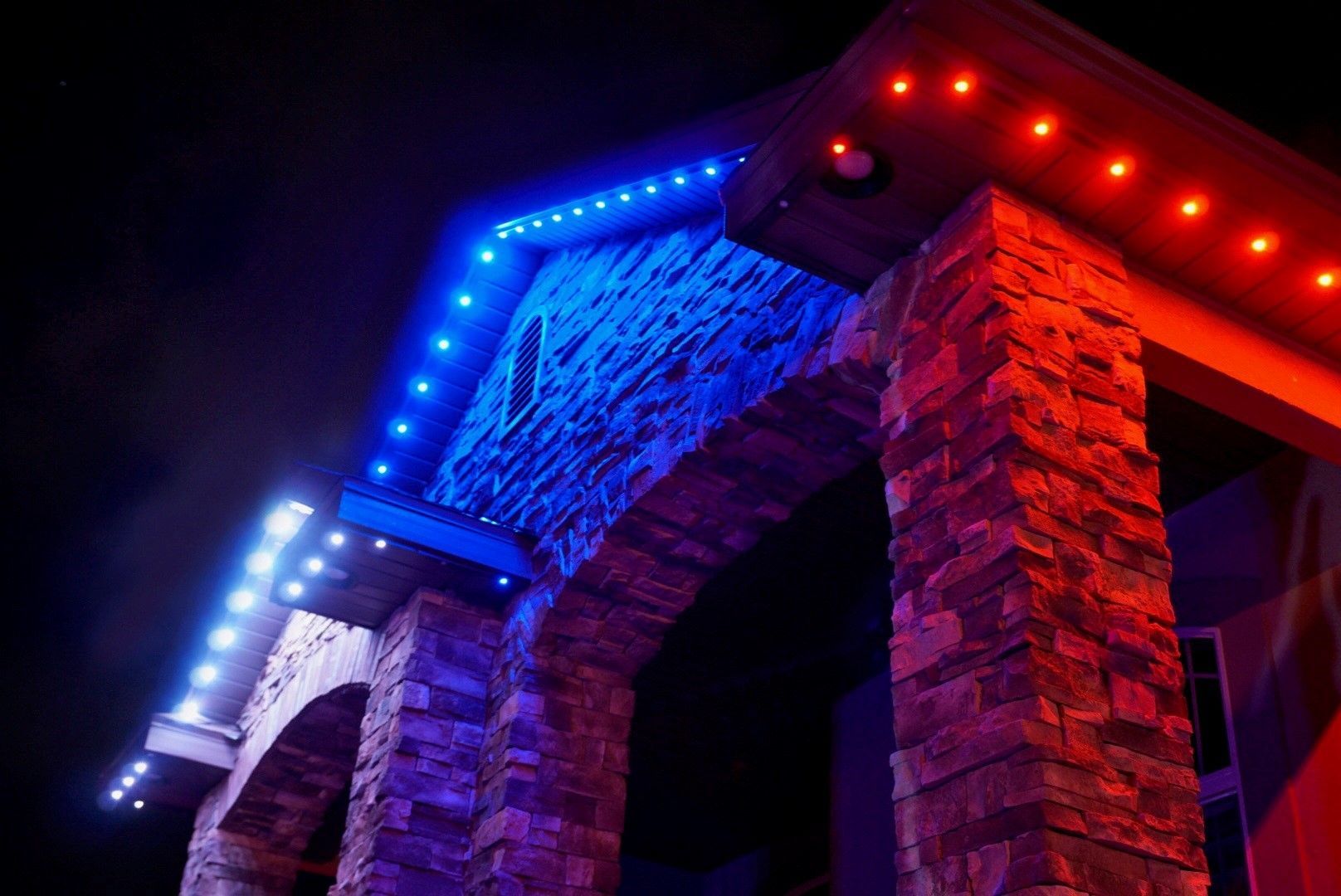 A building with blue and red lights on it at night