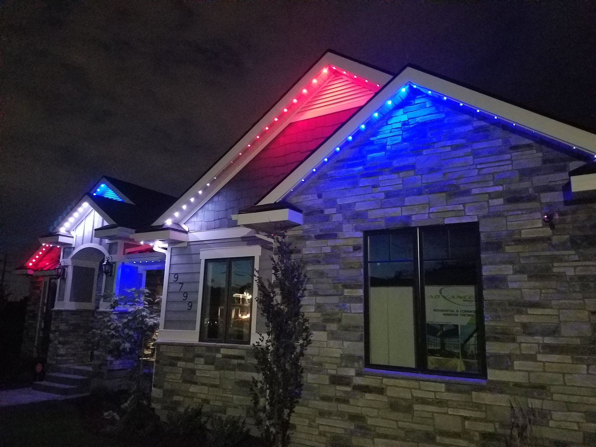 A house is lit up with red, white and blue lights.