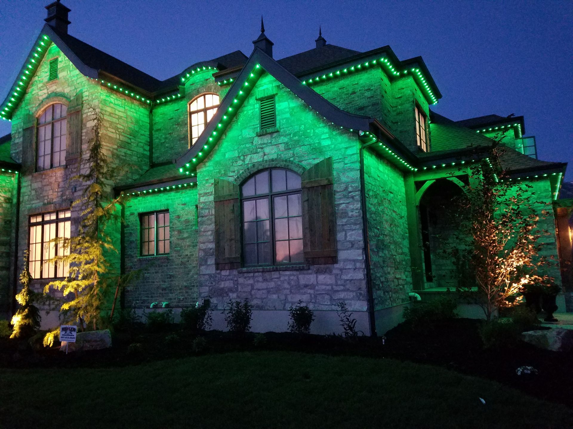 A house with green lights on it at night
