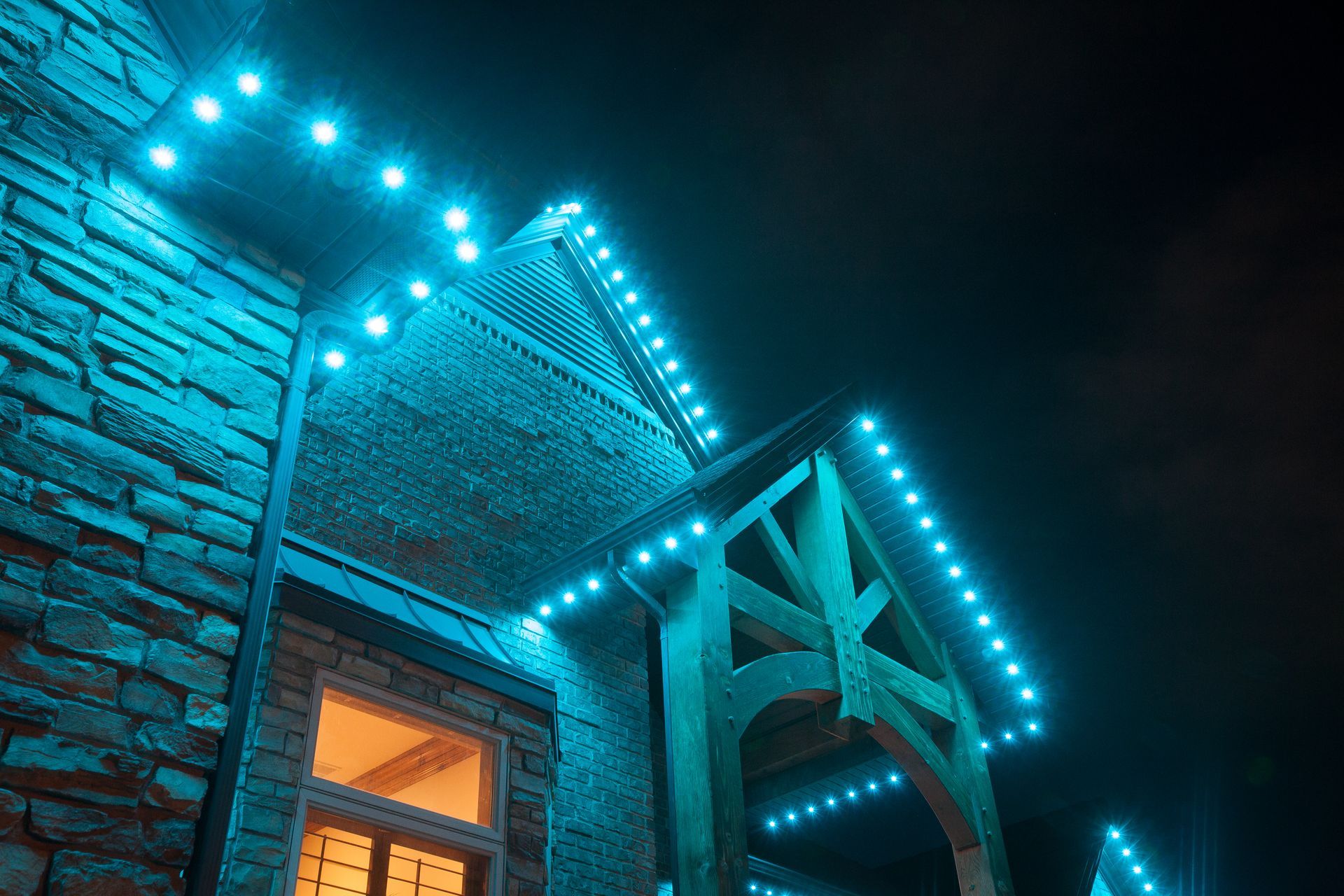 A brick building with blue lights on it at night.