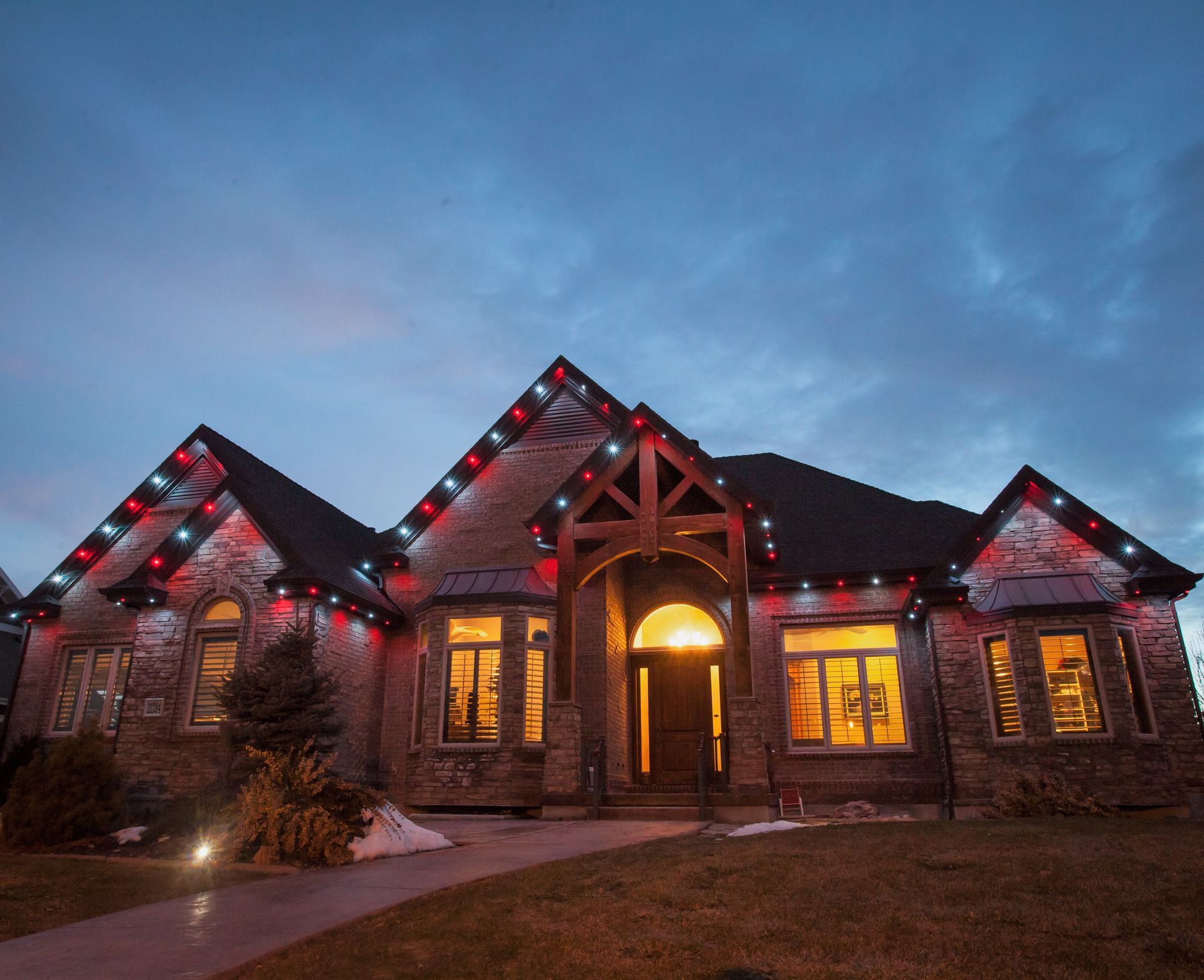A large house with christmas lights on the roof