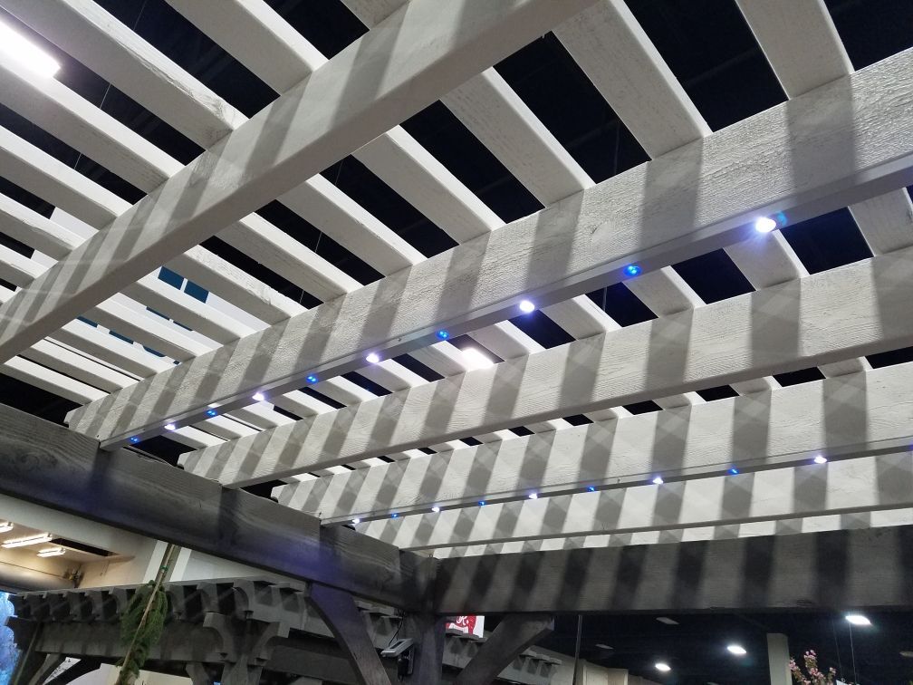 A pergola with blue lights on it at night