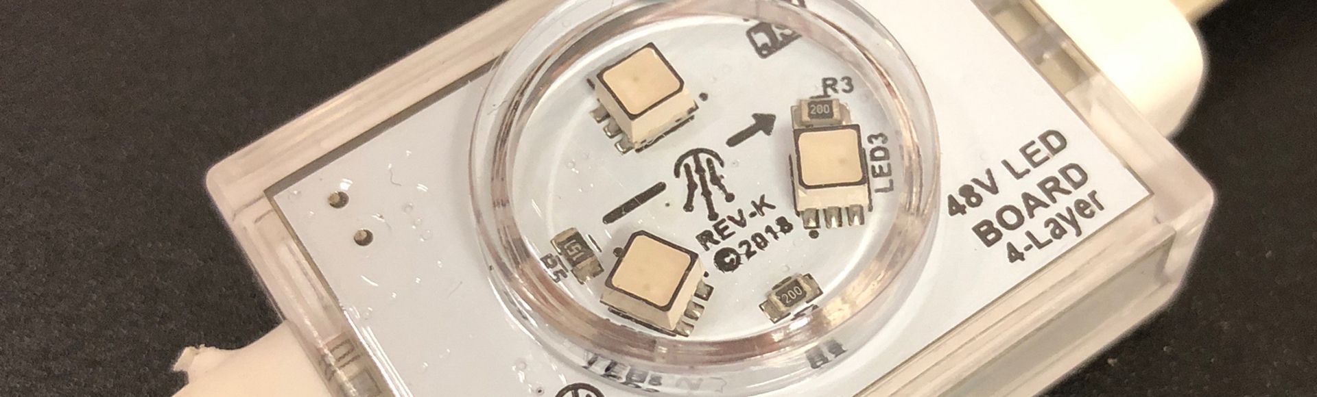 A close up of a 48v led board on a black surface.