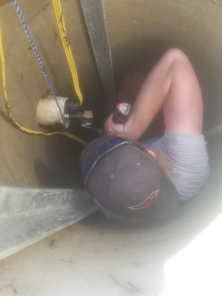 A person is laying on the ground holding a can of soda
