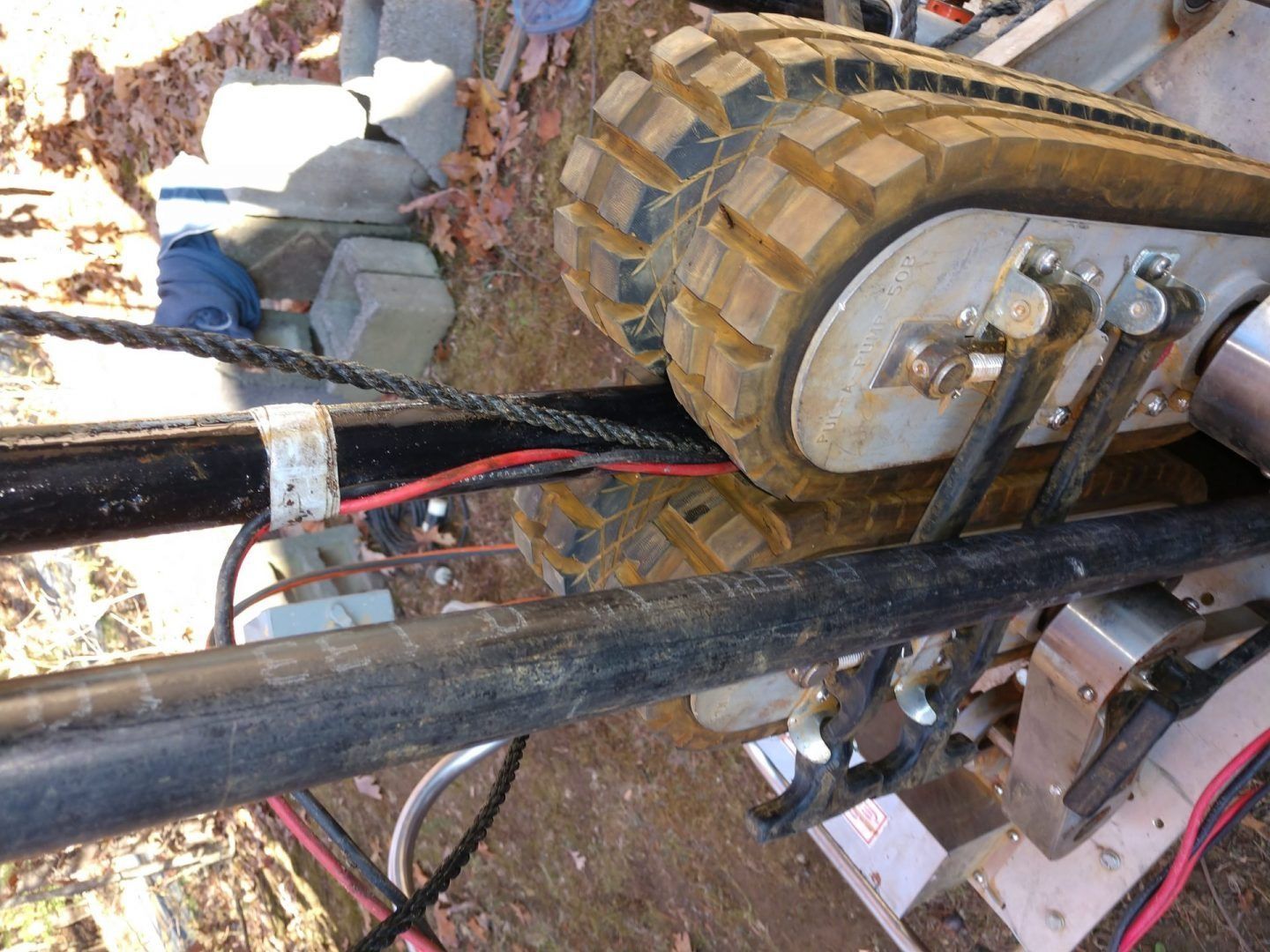 A close up of a machine with red wires coming out of it