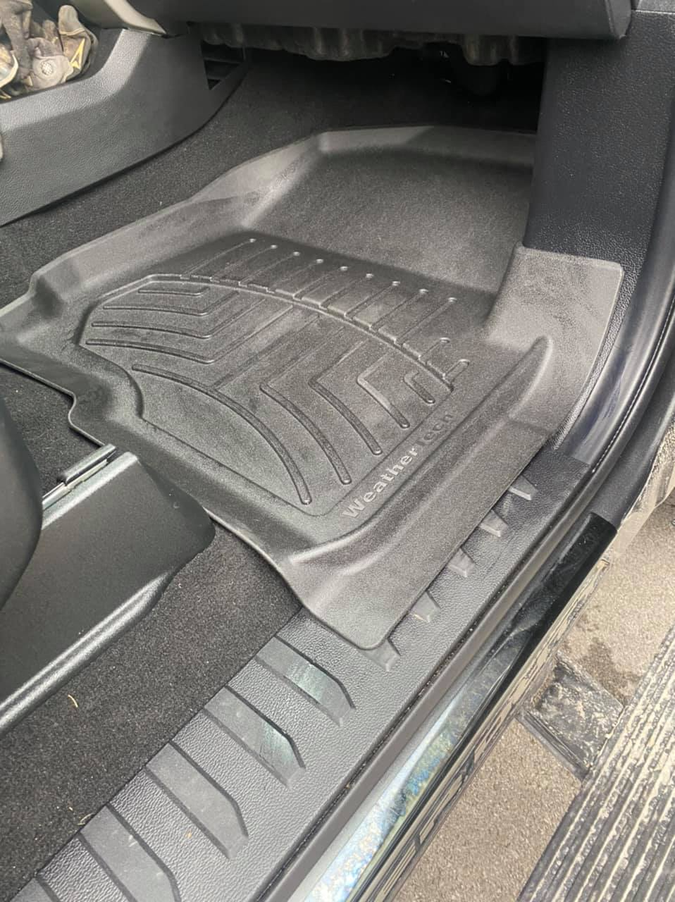 A close up of a car floor mat in a car.