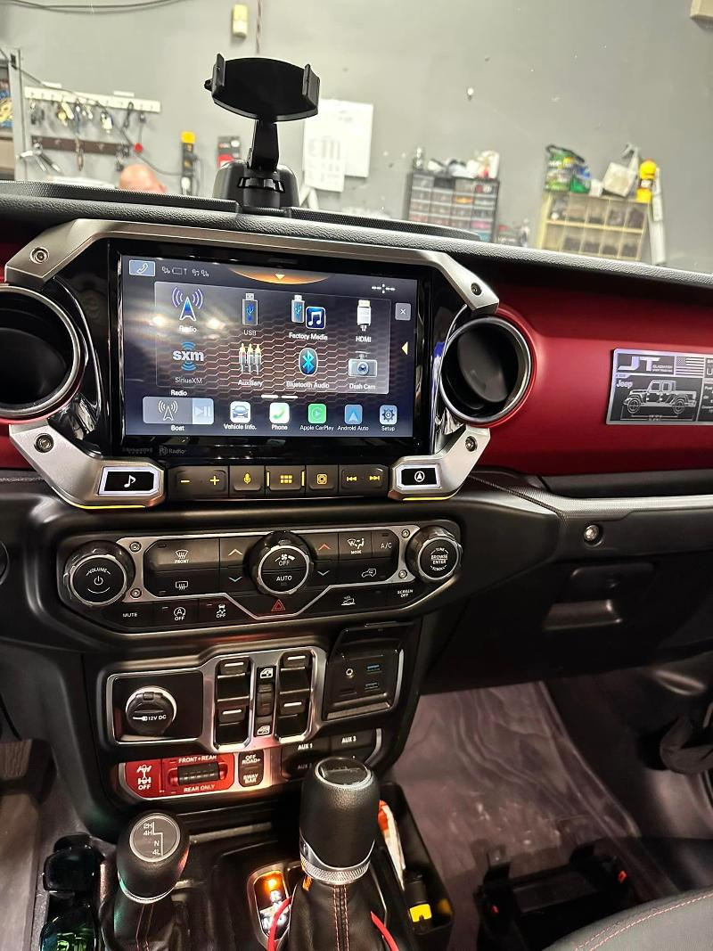 The dashboard of a jeep wrangler with a gps on it.