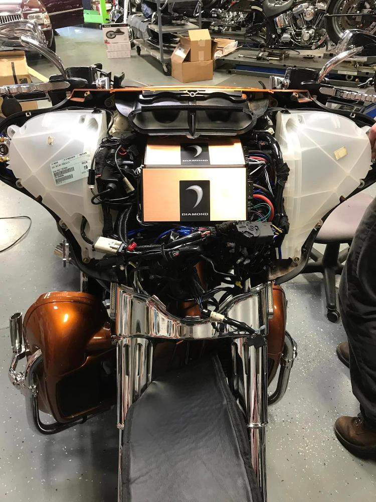 A motorcycle is being worked on in a garage
