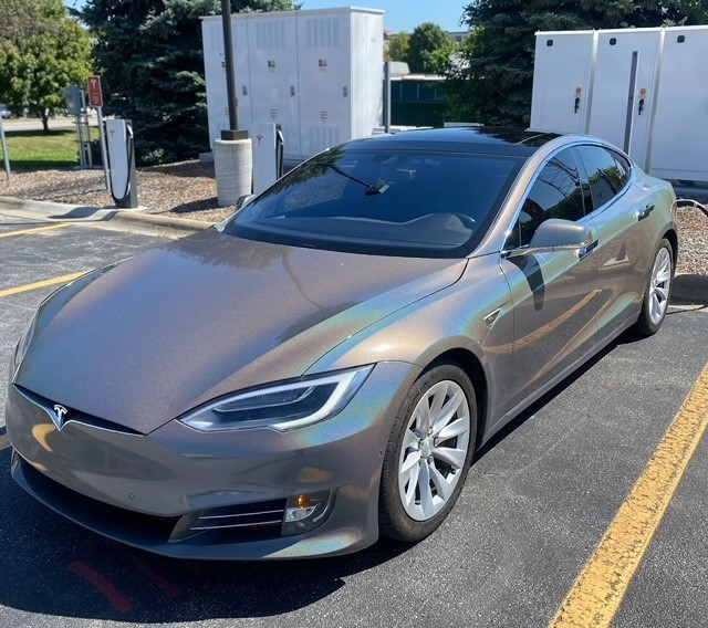 A tesla model s is parked in a parking lot