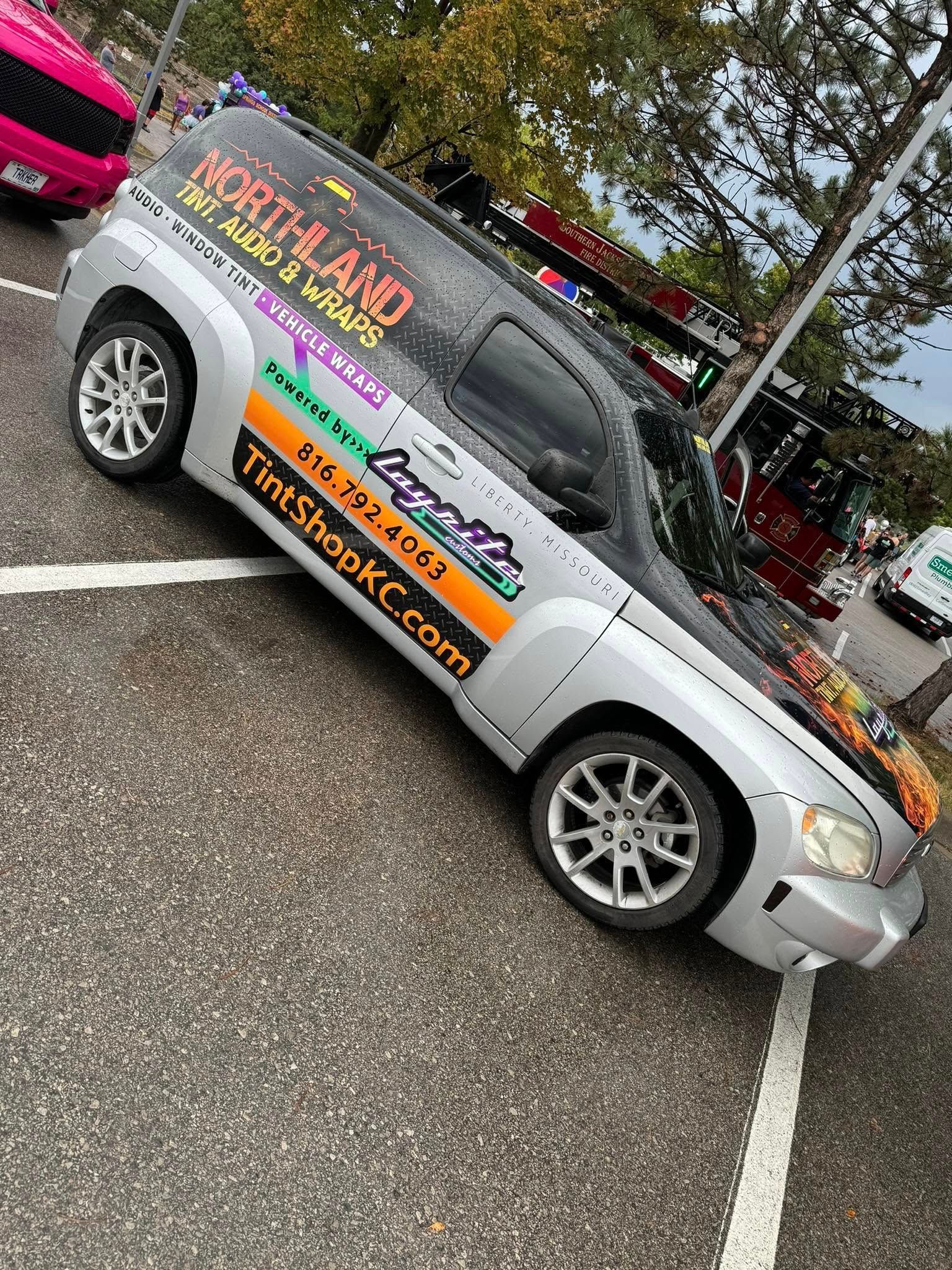 A silver SUV parked in a lot, displaying