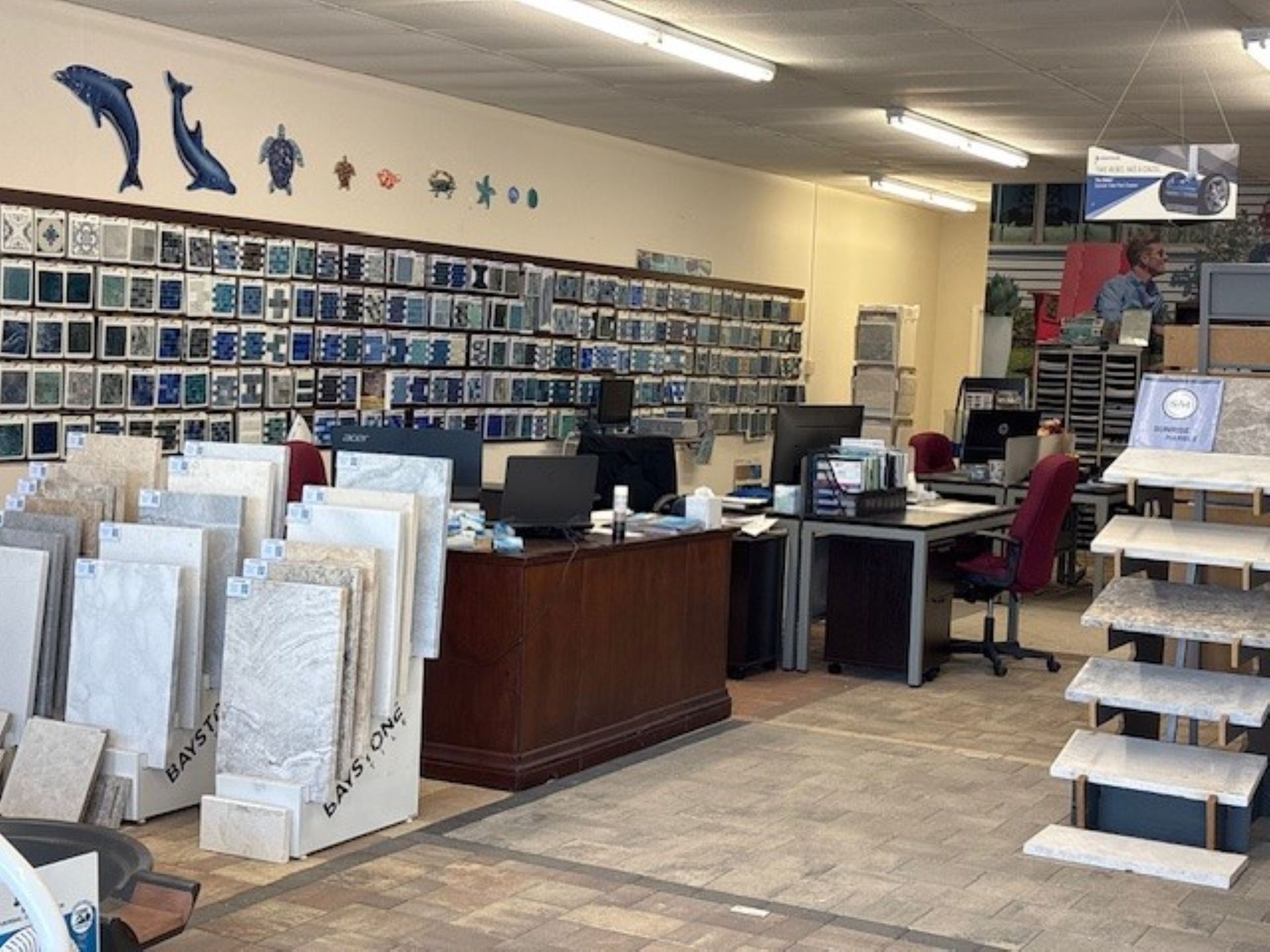 Several hot tubs on display in a store, bubbling water in the closest one.