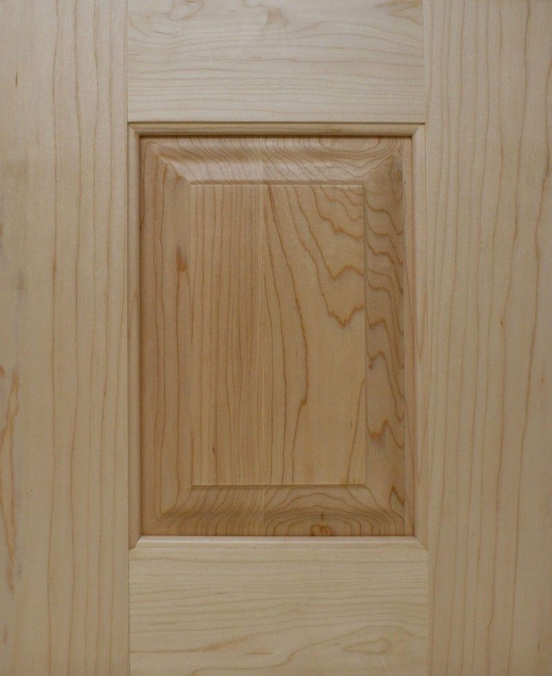 A close up of a wooden door with a square hole in the middle.