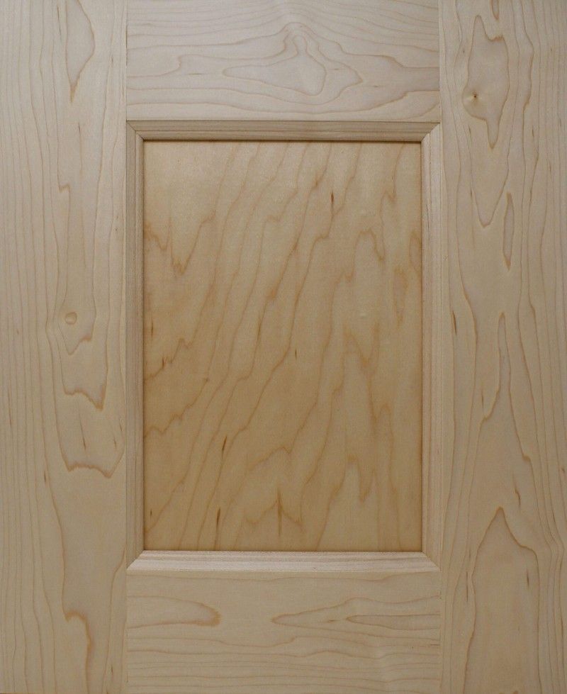 A close up of a wooden door with a square hole in the middle.