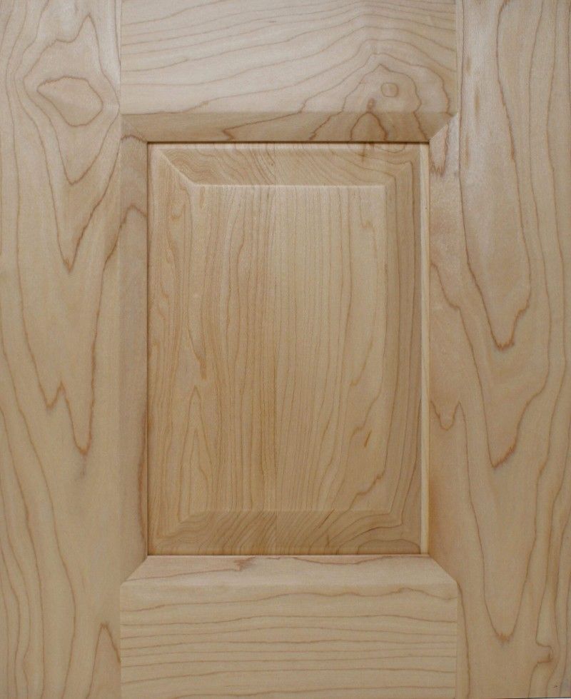 A close up of a wooden door with a square hole in the middle.