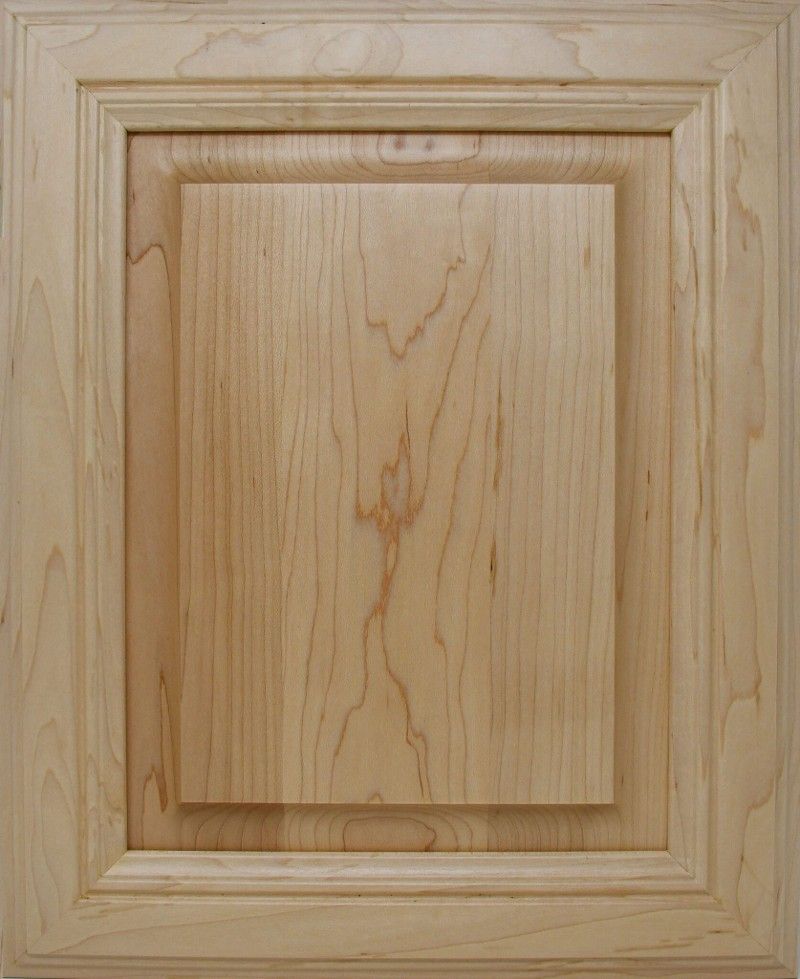 A close up of a wooden cabinet door with a square frame.
