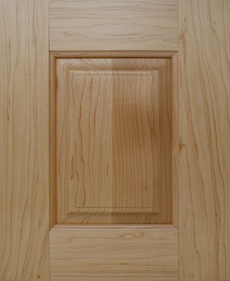 A close up of a wooden door with a square hole in the middle.