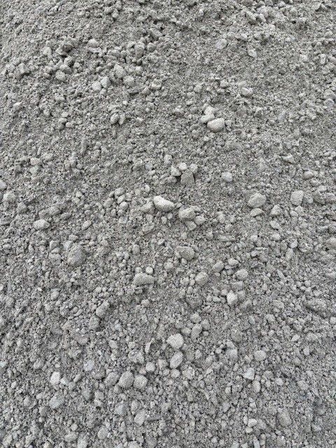 Pile of gray gravel, consisting of small stones and sand-like particles.