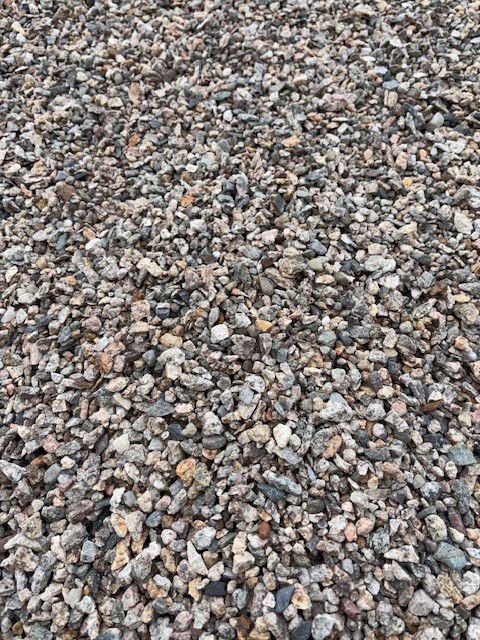 Gravel pile of varying sizes and colors, including gray, brown, and tan.