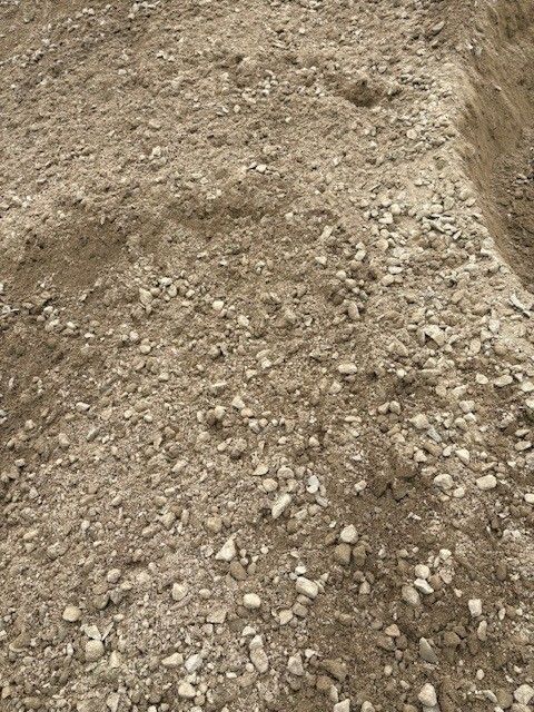 Close-up of a dirt and gravel surface with uneven texture and small rocks