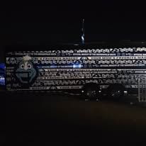 A dark trailer covered in a repeating black-and-white pattern featuring a mascot and the text 