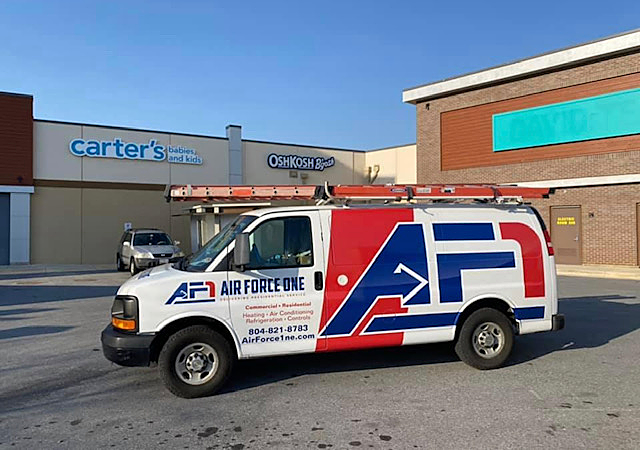 an air force one van is parked in front of a carter 's store