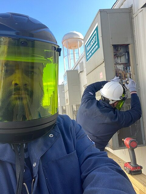 a man wearing a helmet and goggles is working on a building
