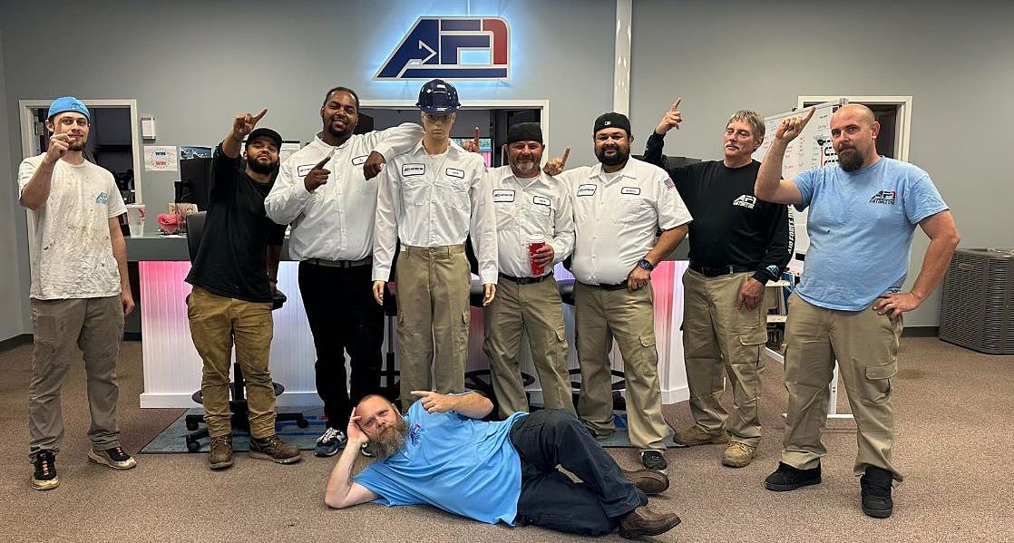 a group of men are posing for a picture in a room .