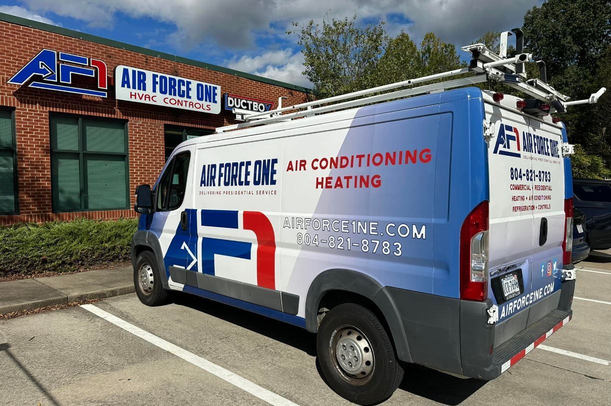 a van is parked in a parking lot in front of a building .