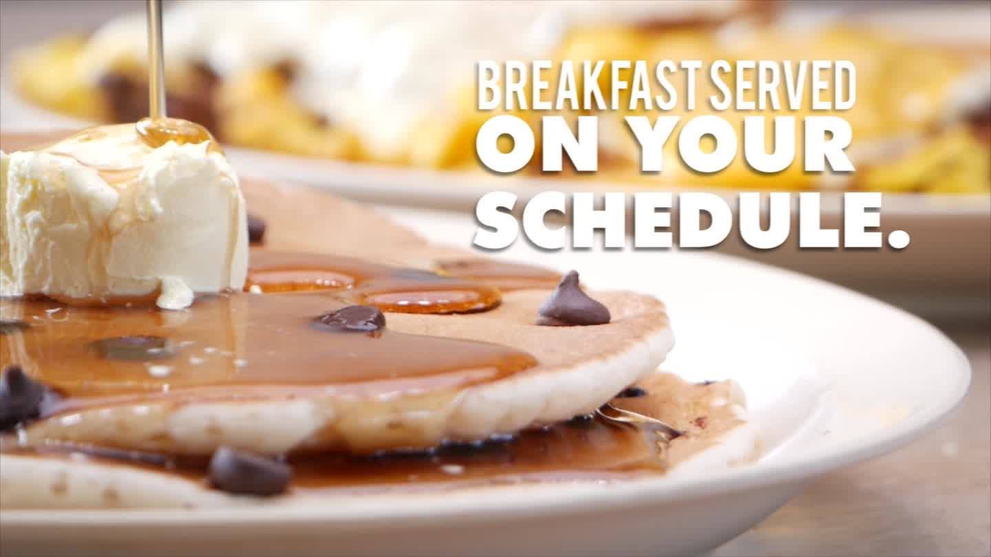 Pancakes with syrup, butter, and chocolate chips; text says 