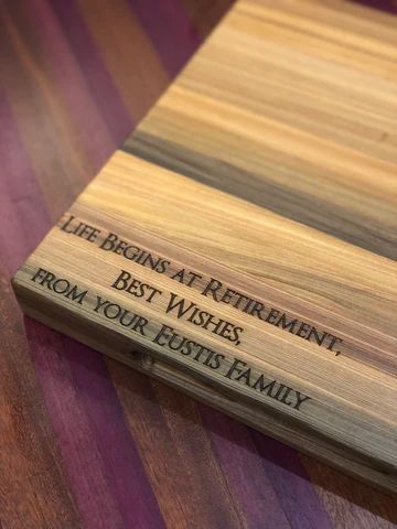 Wooden retirement plaque engraved, 'Life begins at retirement. Best wishes from your Eustis family.'