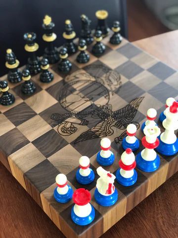 Chess set on a wooden board, with black pieces facing red-white-blue pieces around a central chess engraving.