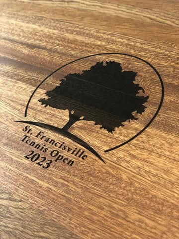 St. Francisville tennis open 2023 logo with tree silhouette engraved on wood