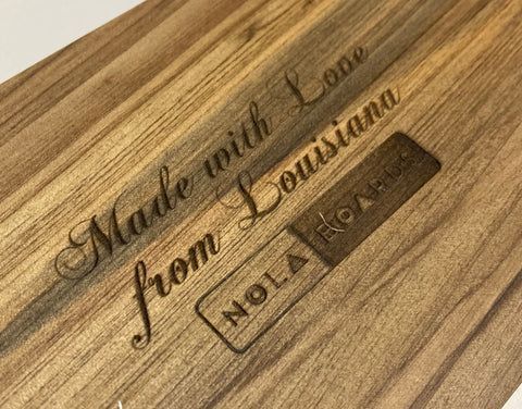 Wooden plaque engraved 'Made with Love from Grandma' with a small 'NOEL' nameplate.