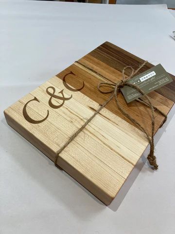 Wooden gift box with 'C&C' engraving, tied with twine and a small tag.