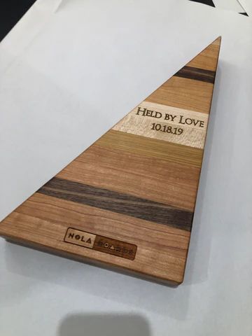 Wooden triangular plaque with 'Held in Love 28.12.19' engraved on it