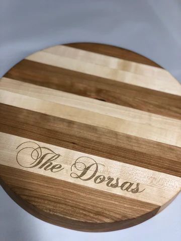Round striped wooden sign engraved 'The Dorsas'