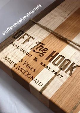 Stack of books with the cover of The Hook by Mark McDonald on top, in brown and beige tones