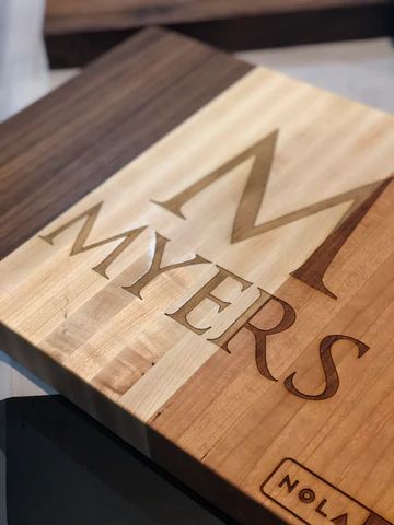 Wooden plaque engraved with a stylized M and the word 'MYERS,' with a small 'NOLA' mark.