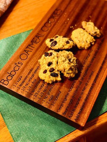 Oatmeal cookies on a wooden tray with a green napkin on a table