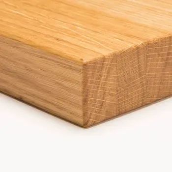 A close-up, angled view of a rectangular block of light-colored oak wood showing its natural grain and end-grain texture.