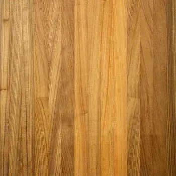 Close-up of a warm, light-brown wood surface with vertical grain patterns and textured panel joints.