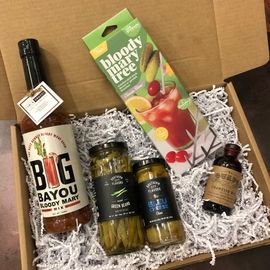 Gift box with liquor bottle, Bloody Mary mix, pickles, olives, and a small bottle of hot sauce