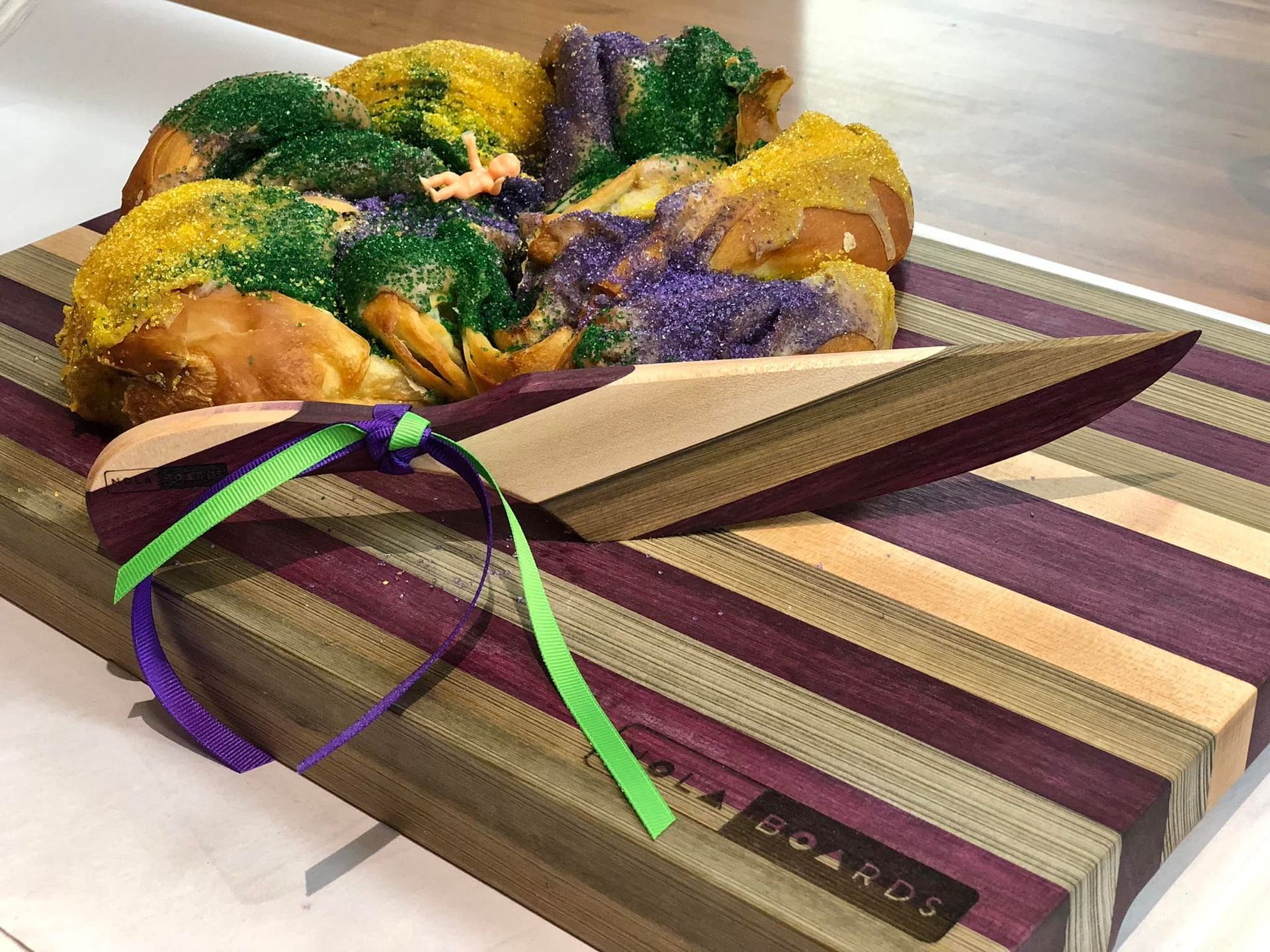 Three wooden spoons are sitting on a wooden cutting board