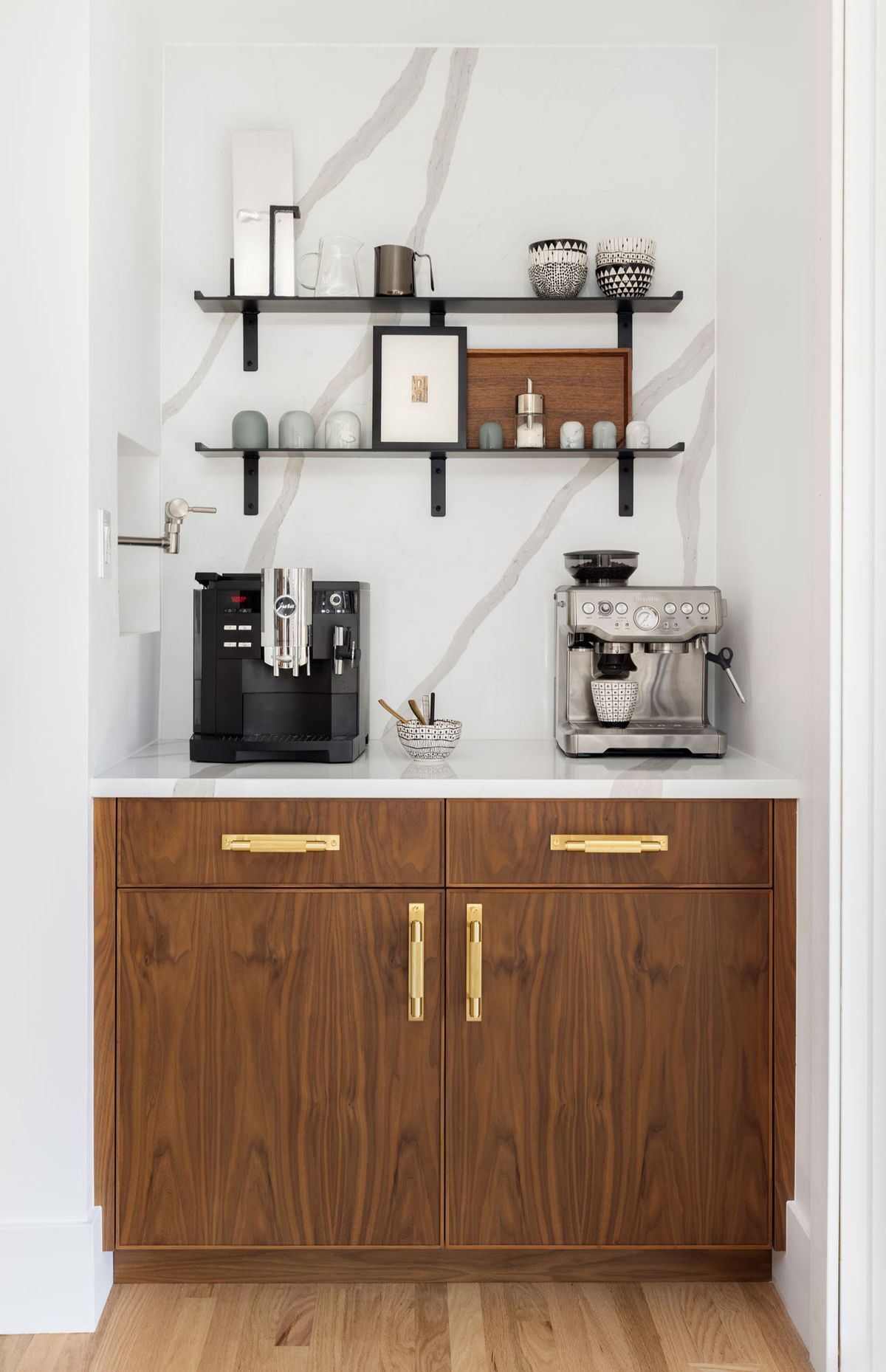 A kitchen with wooden cabinets and a coffee maker on the counter.